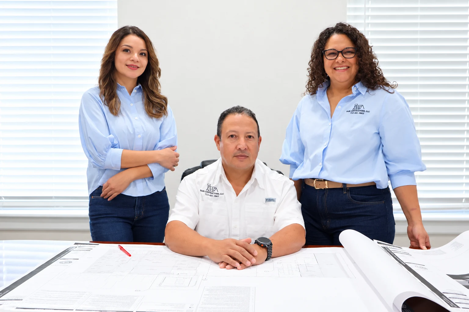 Fair Contractors team members reviewing plans at the office